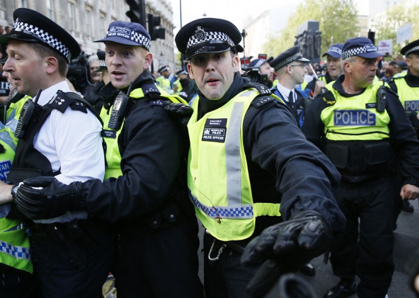 Police try to push back demonstrators at the gates of Downing Street.
