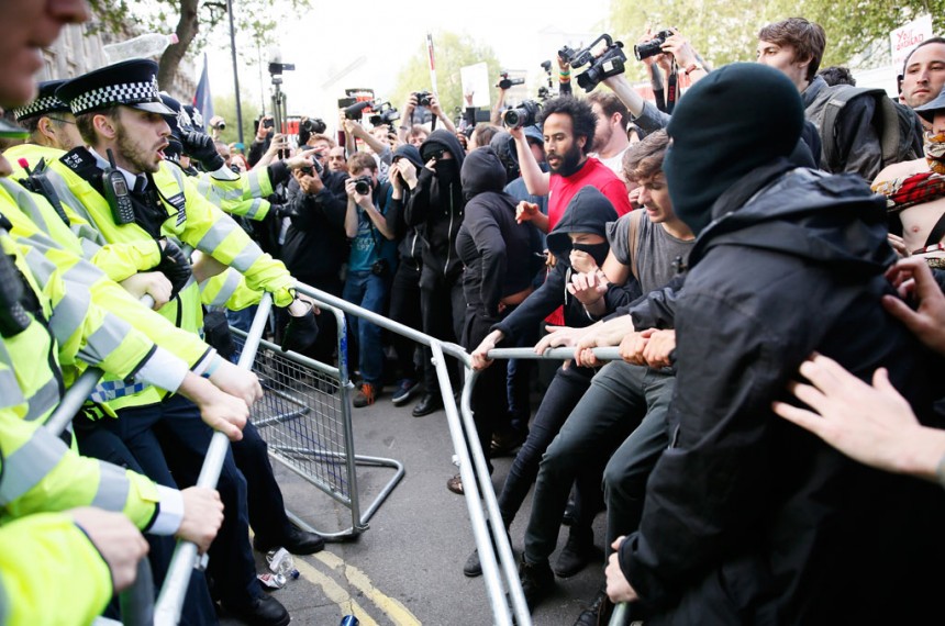 Protesters and police face off at the gates of Downing Street during a protest in London
