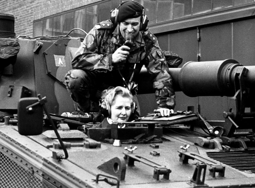 This picture taken on January 23, 1976 shows Margaret Thatcher, then chairwoman of the British Conservative Party, and lieutnant Parradine sitting on a tank of the 7th regiment of the Royal Signals in Herford, western Germany. Margaret Thatcher, the "Iron Lady" who shaped a generation of British politics, died following a stroke on April 8, 2013 at the age of 87, her spokesman said.      AFP PHOTO / GERMANY OUT        (Photo credit should read -/AFP/Getty Images)