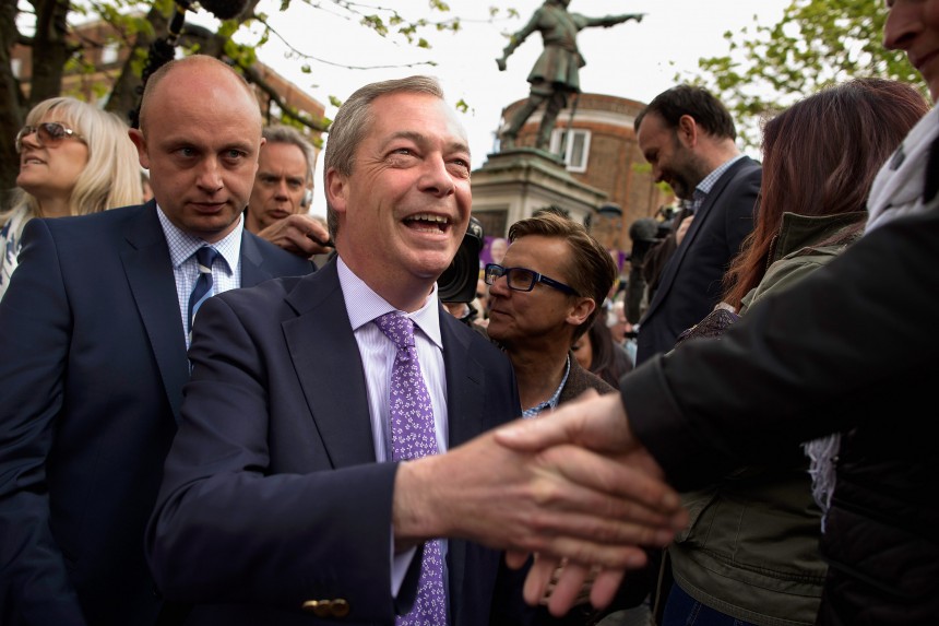 AYLESBURY, UNITED KINGDOM - APRIL 30:  UK Independence Party (UKIP) leader Nigel Farage (C) campaigns with UKIP parliamentary candidate Chris Adams (L) underneath a statue of John Hampden in Market Square on April 30, 2015 in Aylesbury, England. A natural campaigner, Farage has a confidence and charisma that invites a crush of party supporters, journalists and curious onlookers whenever he appears in public. Farage made of point of talking about Aylesbury being the home of John Hampden, a leading 17th century parliamentarian involved in challenging the authority of Charles I of England and who died during battle in 1643 during the English Civil War.  (Photo by Chip Somodevilla/Getty Images)