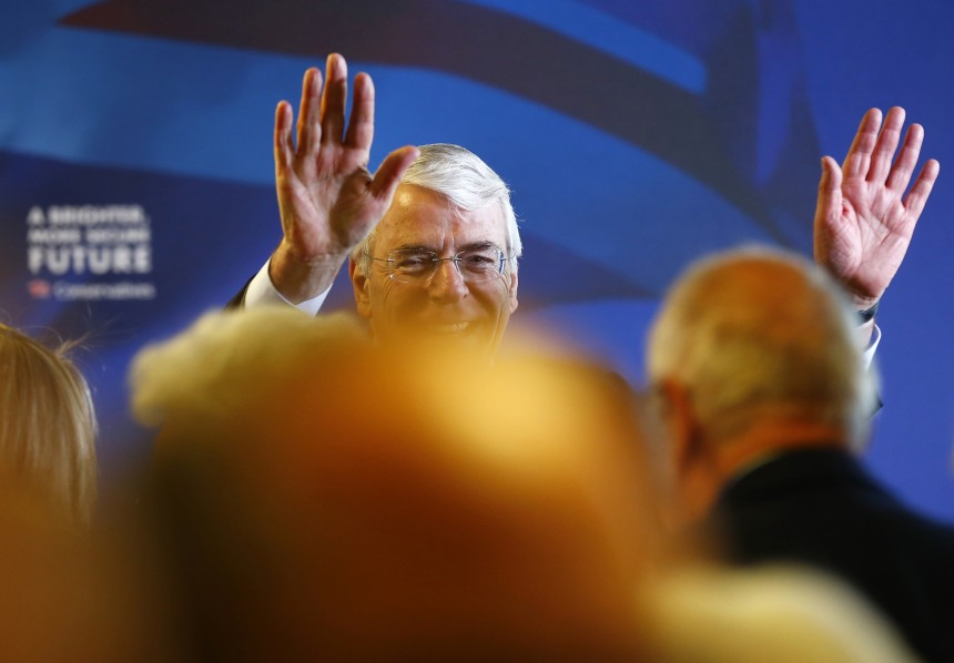 Britain's former Conservative Prime Minister John Major waves after making a campaign speech at a sports club in Solihull