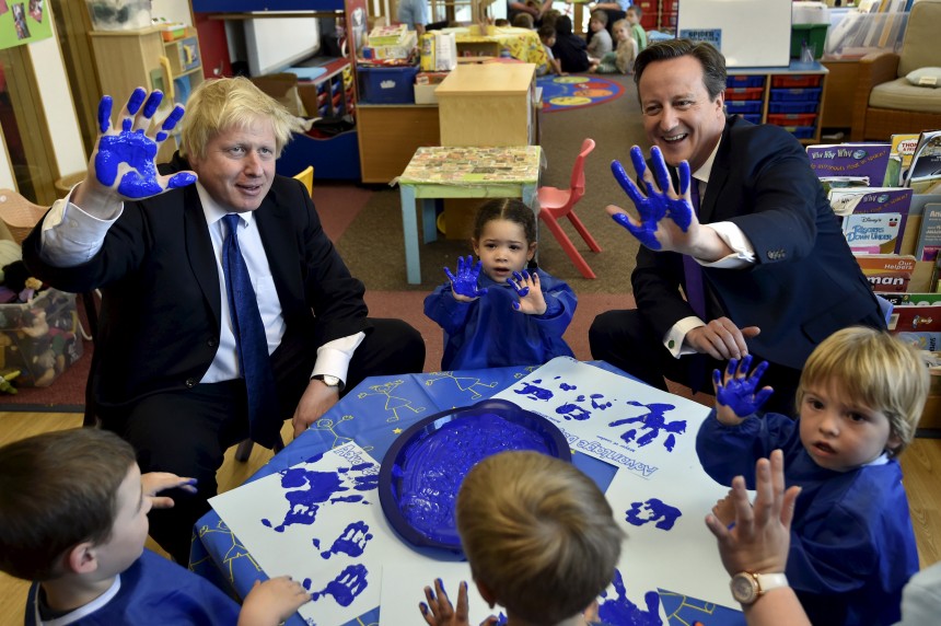 Britain's Prime Minister Cameron and London Mayor Johnsonreact as they join a hand-printing session with children at the Advantage children's daycare nursery in Surbiton in south west London