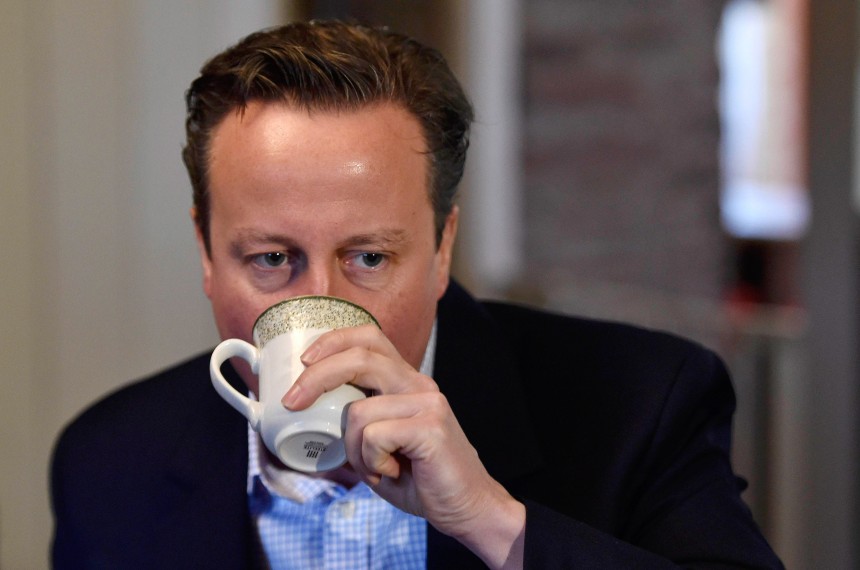 BRECON, WALES - MAY 6:  Prime Minister David Cameron enjoys a hot drink while he visits local members of the farming community during a campaign visit at Whole House Farm, on May 6, 2015 near Brecon, Wales. Britain's political leaders are campaigning in a final day's push for votes ahead of what is predicted to be the closest General Election for a generation. (Photo by Toby Melville - WPA Pool/Getty Images)